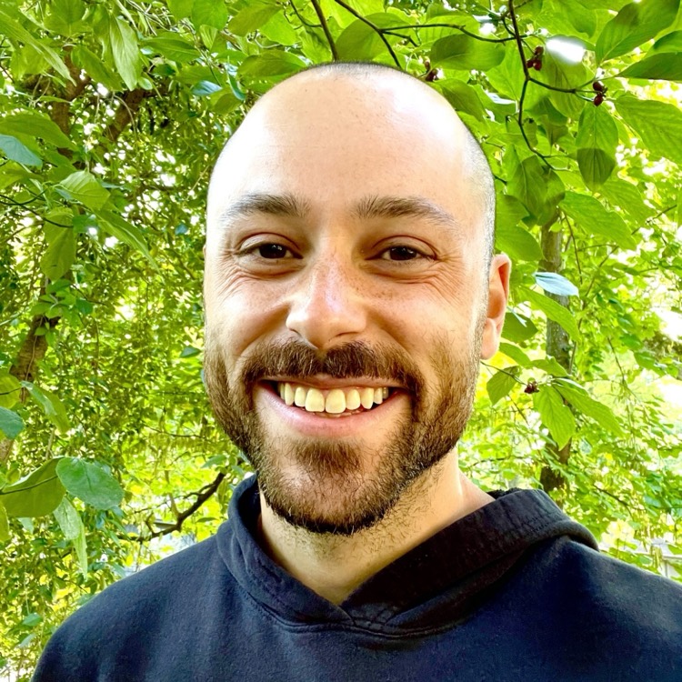 Jack Rome, standing outdoors and smiling.